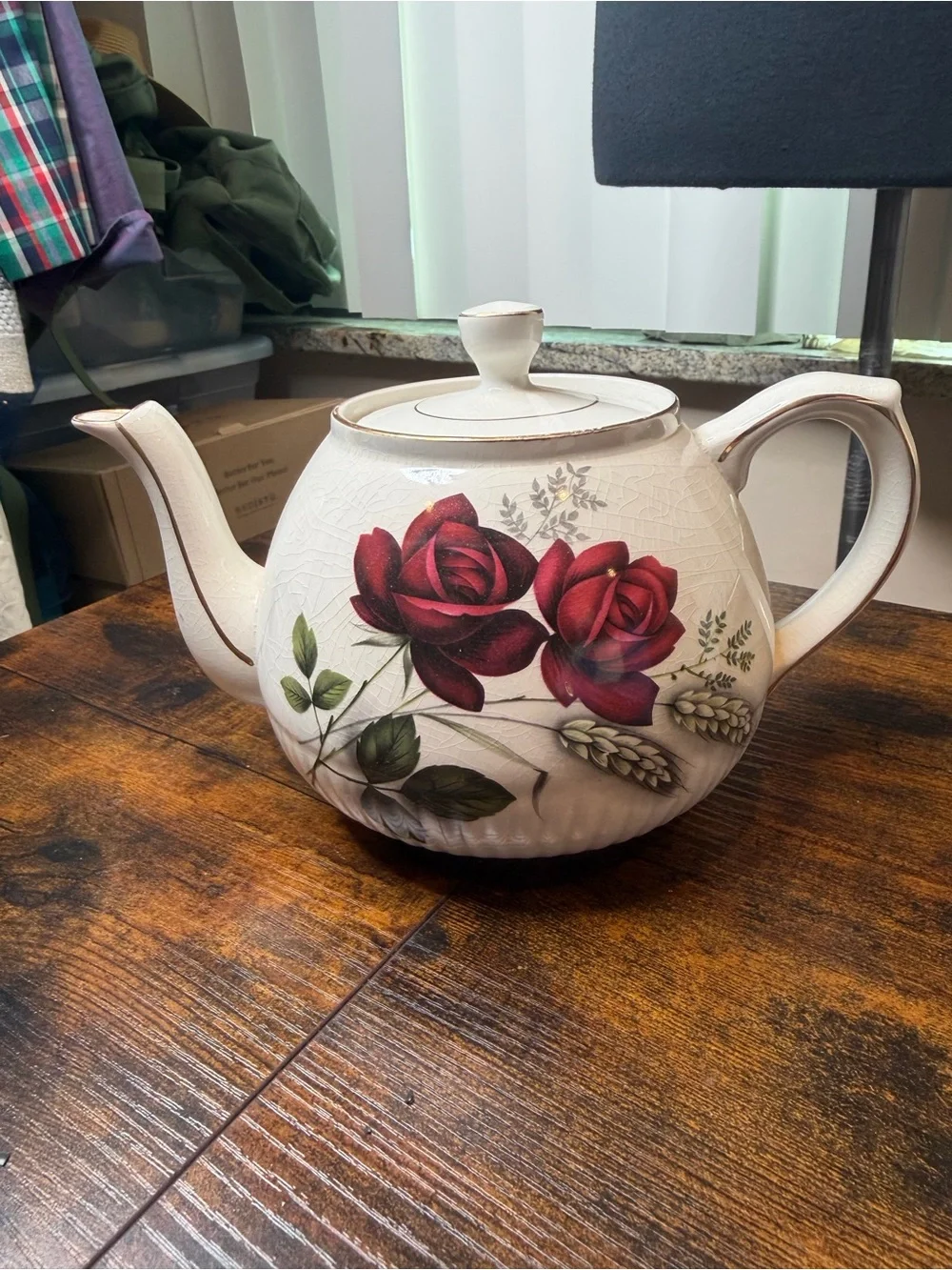 Vintage Ellgreave England red rose teapot featuring delicate gold trim.